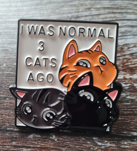 Pin badge.I was normal 3 cats ago.