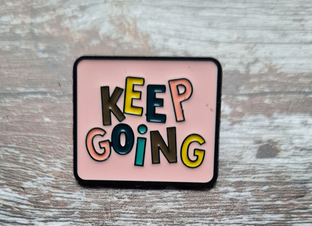 Pin badge.Keep going